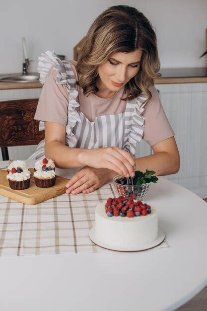 Premium Photo Women S Hands Decorate Muffins With Fresh Blueberries