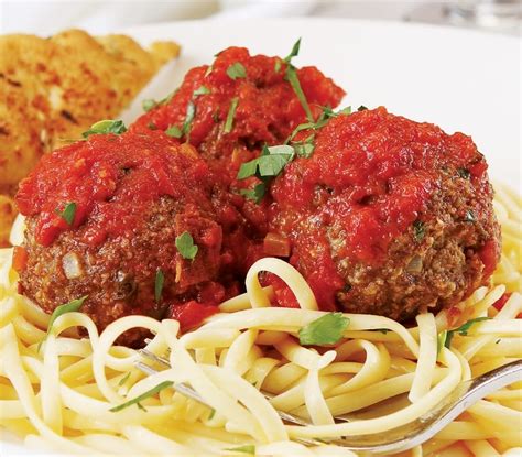 Beef Meatballs over Spaghetti with Garlic Bread - Prepared Food Photos, Inc.