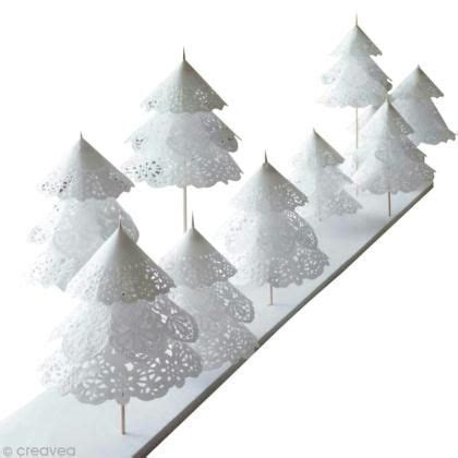 Several White Paper Trees Are Lined Up In A Row