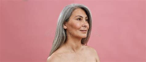 Senior Naked Caucasian Woman Looking Away While Posing With Jar Of