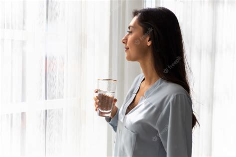 Premium Photo Adult Caucasian Woman Drinks Glass Of Pure Water In The