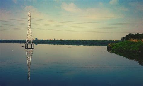 Premium Photo Reflection Of Electricity Pylon On Lake