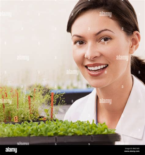 Female Scientist Smiling Near Plants In A Laboratory Stock Photo Alamy