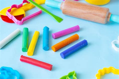 Colorful Sticks Plasticine With Cutters Knife And Roller On A Blue