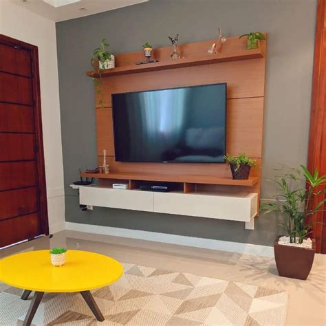 A Living Room With A Yellow Coffee Table And Television On The