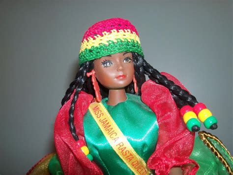 a doll with braids wearing a green and red dress