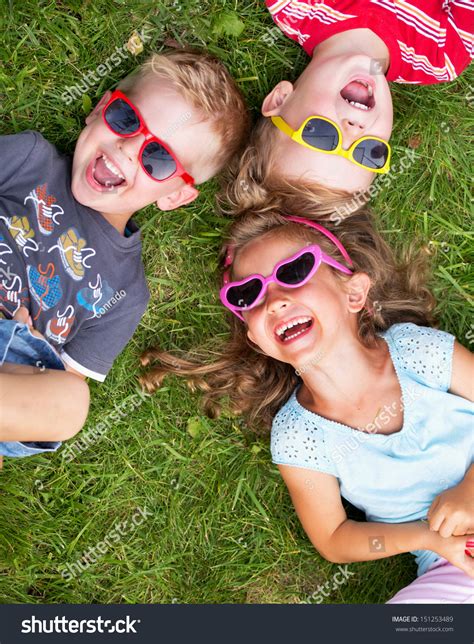 Cheerful Kids Laying On A Grass Stock Photo 151253489 : Shutterstock