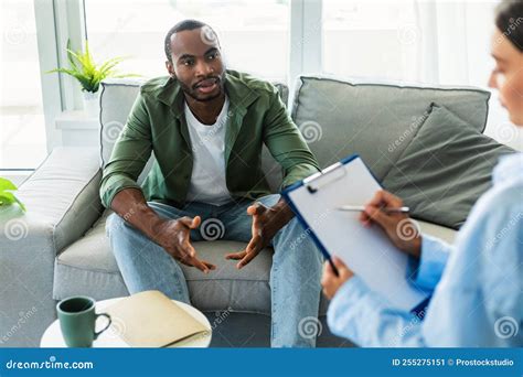 Black Man Suffering From Depression Counselor Providing Professional Assistance At Medical