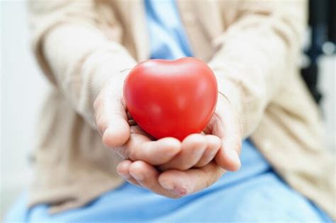 Paciente Idosa Asi Tica Segurando Cora O Vermelho No Hospital Foto