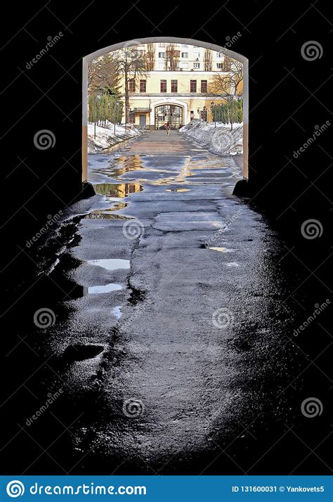 Arch in a Dark Alleyway with Wet Asphalt after the Rain that Falls on ...