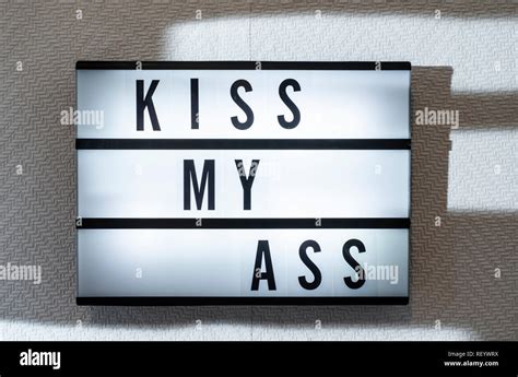 Message Kiss My Ass On Illuminated Board Welcoming Concept With Text Daylight From Window