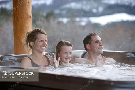 Mature Couple With Their Daughter Relaxing In A Hot Tub SuperStock