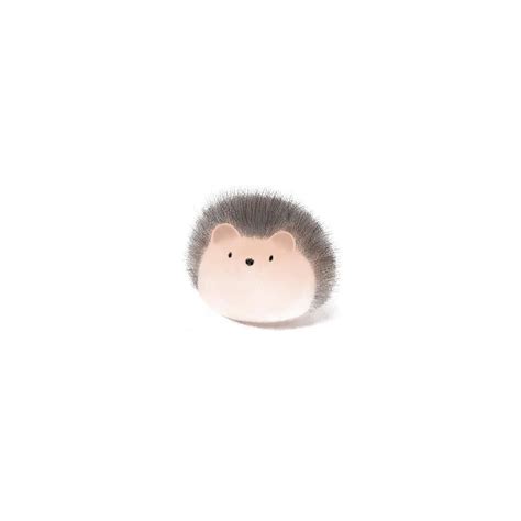 A Hedgehog Toy Sitting On Top Of A White Surface