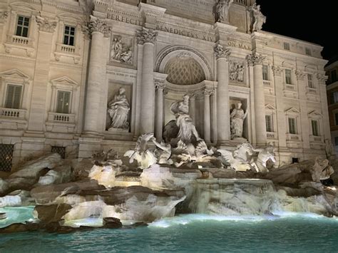 Premium Photo | The trevi fountain at night with the water fountain in ...