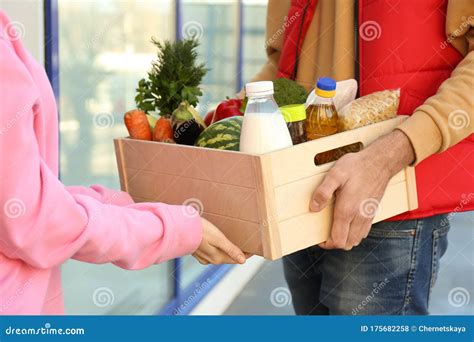 Woman Receiving Fresh Products From Courier Closeup Food Delivery