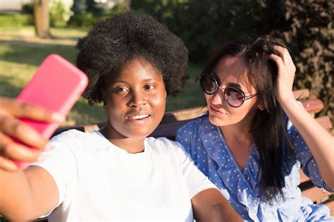 Premium Photo Happy Girls Of Different Nationalities Take Selfies In