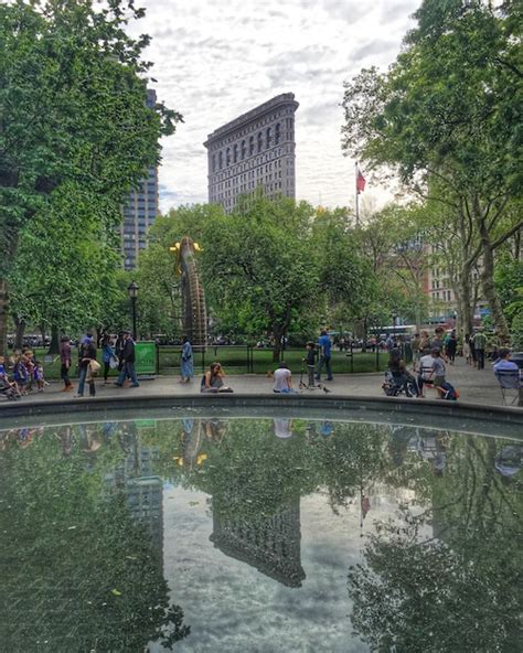 Premium Photo People Relaxing By Pond Against Flatiron At Madison