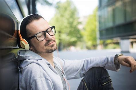 Premium Photo Side View Of Mature Man Listening Music While Sitting