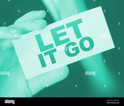 Closeup On Businessman Holding A Card With Text Let It Go Business