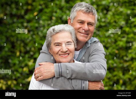 Mature Couple Hugging In The Garden Stock Photo Alamy