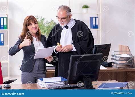 Old Male Judge And His Young Secretary In The Office Stock Image