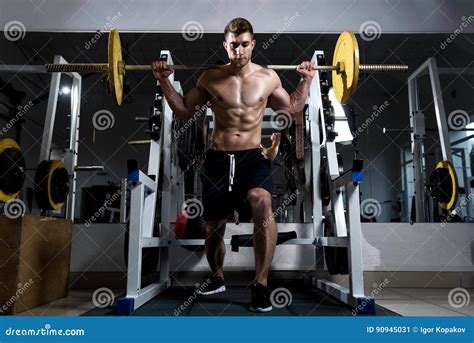 Man With A Naked Torso Doing Squats In The Gym Stock Image Image Of