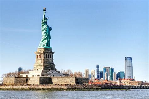 Premium Photo | Statue of liberty with city in background