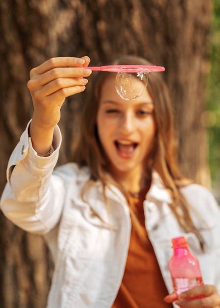 Heureuse Jeune Femme Faisant Des Bulles De Savon Photo Gratuite