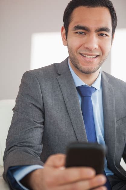 Premium Photo Smiling Businessman Sending A Text Message