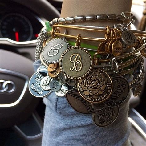 a person wearing a bracelet with lots of charms on it's arm in a car