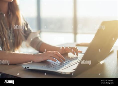 Female Writer Typing Using Laptop Keyboard At Her Workplace In The