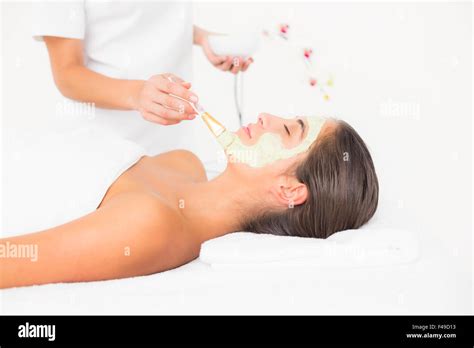 Beautiful Brunette Getting A Facial Treatment Stock Photo Alamy