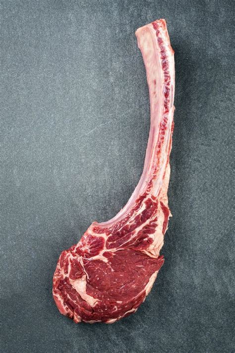 Raw Wagyu Tomahawk Beef Steak With Salt And Pepper On A Gray Design