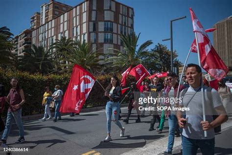 Protesters are seen holding communist party flags as they take part ...