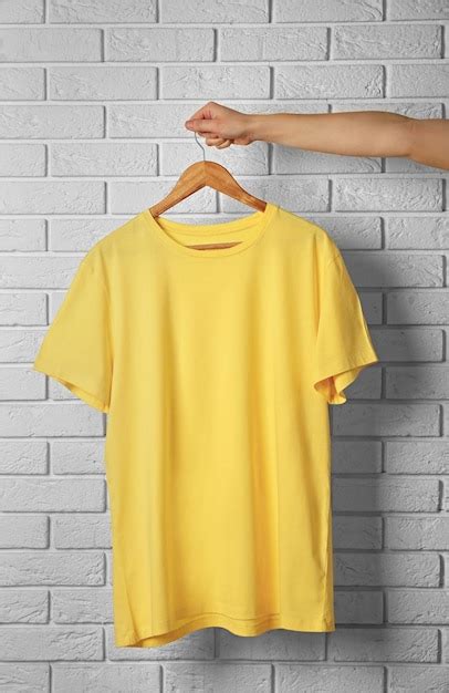 Premium Photo Blank Yellow Tshirt Against Brick Wall