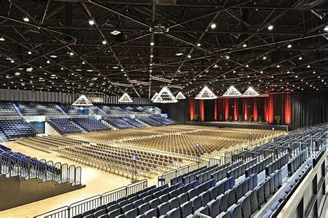 An Empty Auditorium With Rows Of Seats And Lights On The Ceiling Is