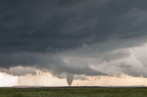 A Cone Tornado Touches Down Under the Base of a Dark Storm on the ...