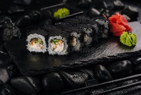 California Rolls Covered Black Tobiko on a Black Board Stock Image ...