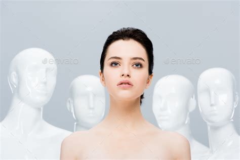 Beautiful Naked Girl Posing Near Mannequins Isolated On Grey Stock Photo By LightFieldStudios