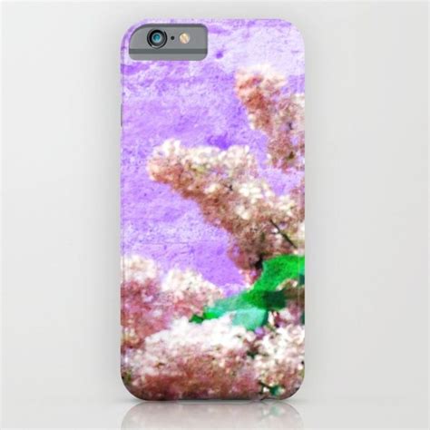 An Iphone Case With Flowers And Leaves On The Front Against A Purple