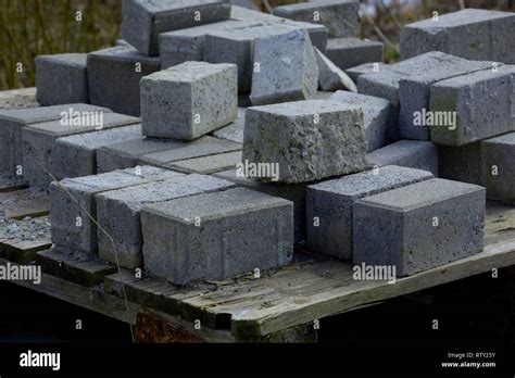 Stack Of Concrete Paving Blocks And Kerbs On A Wooden Pallet Gray