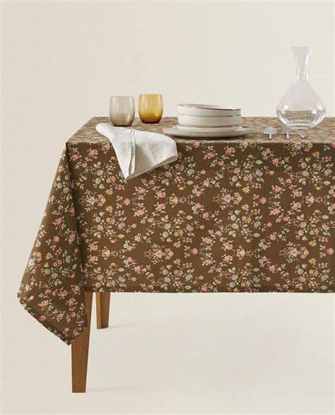a table topped with plates and glasses next to a vase