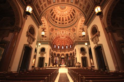 The Inside Of A Church With Pews And Lights