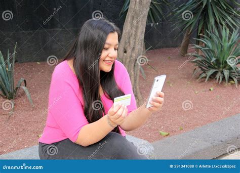 40 Year Old Latina Woman Uses Credit Card And Cell Phone To Make Purchases And Payments Online