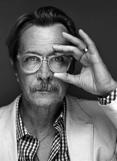 Black And White Photograph Of A Man With Glasses Holding His Hand Up To