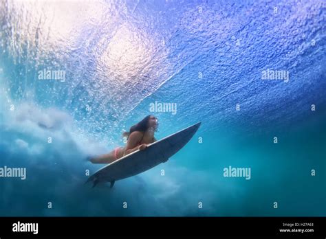 Sportive Girl In Bikini In Surfing Action Surfer With Surf Board Dive