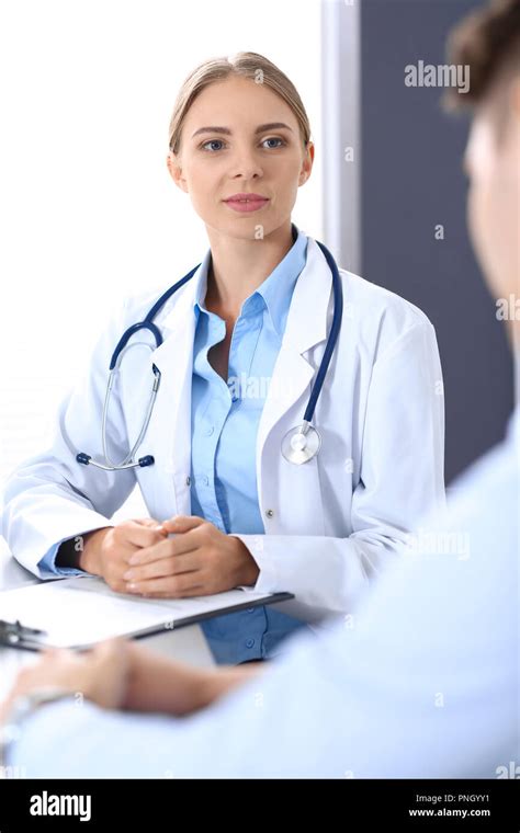 Doctor And Patient In Hospital Beautiful Blonde Physician Consulting Business Man About His