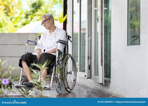 Old Elderly Patient With Disabilities Sit Alone In A Wheelchair At Home