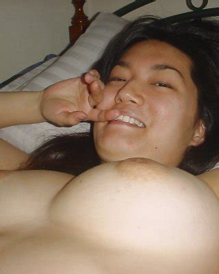 Seductive Asian Babe Slipping Off Her Clothes And Showing Off Her Big Tits Porn Pictures XXX