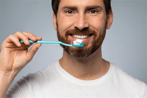 Premium Photo Happy Caucasian Man Cleaning Teeth With Toothbrush And